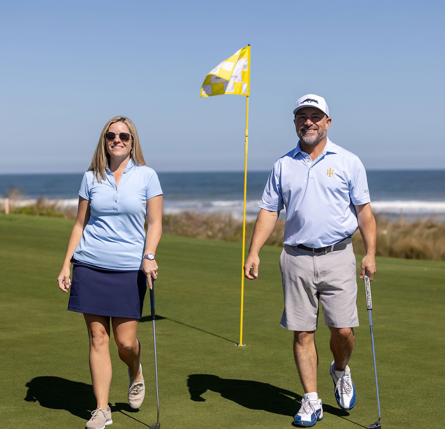 John Demers and Chrissie Capps playing golf